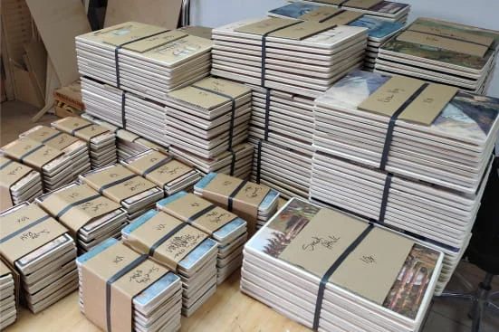 Stacks of Glastrix print orders, packed and ready to ship