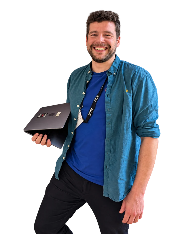 Waldo Vanderhaeghen smiling, holding a closed laptop under his arm